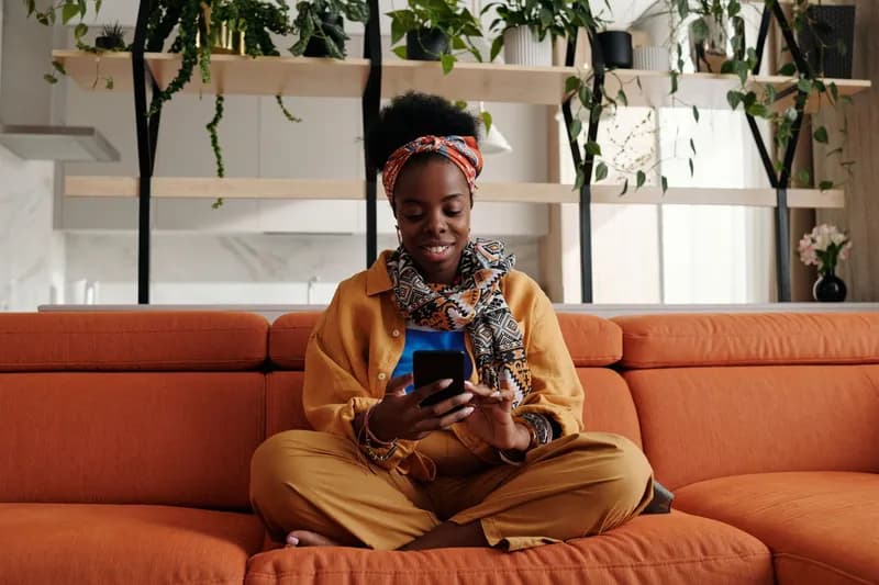 A woman using her phone at home to post a service request